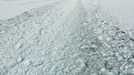 broken ice sheet shipping lane path in the arctic caused by icebreaker ship, aerial