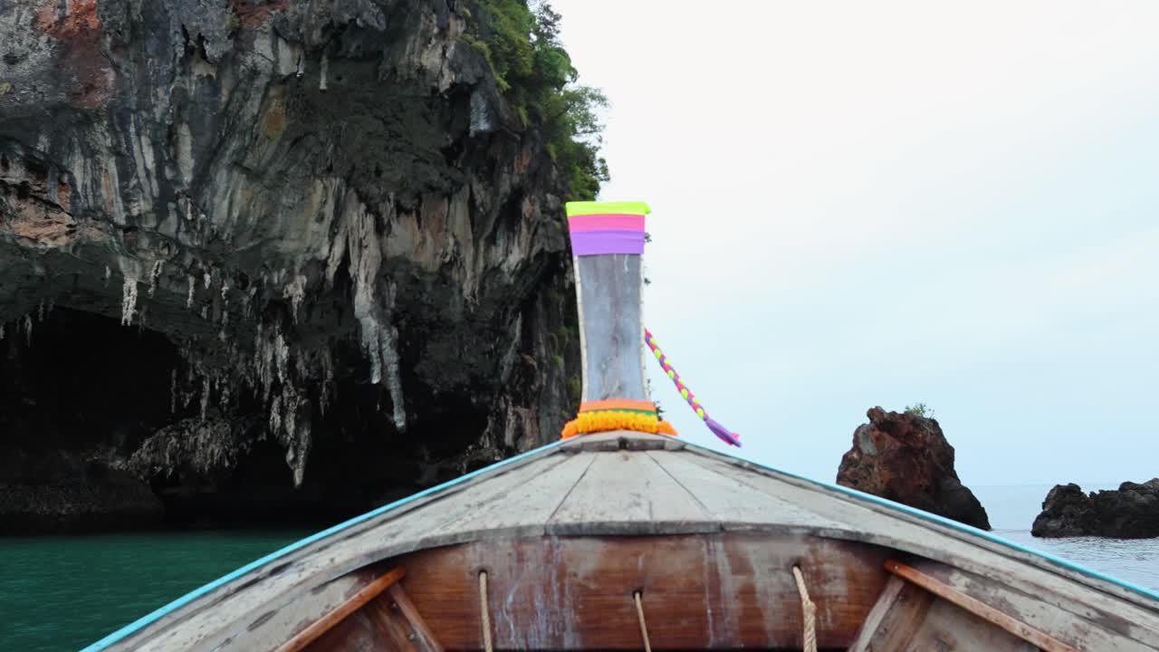 배 는 조용 한 물 에서 바위 섬 에 접근 한다