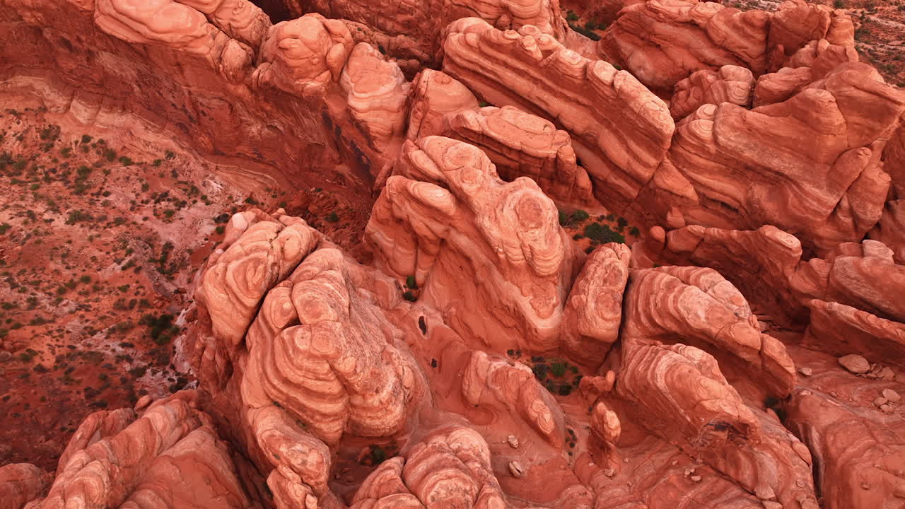 Pillared red rocks with rounded tops in the Arches National Park, Utah, USA. Drone rising over the whimsical canyons and desert