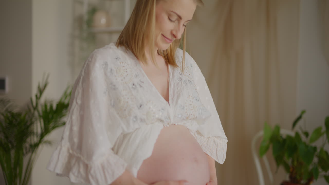 Pregnant Woman Touching Her Belly Joyfully