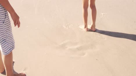 Happy-kids-standing-on-the-sand