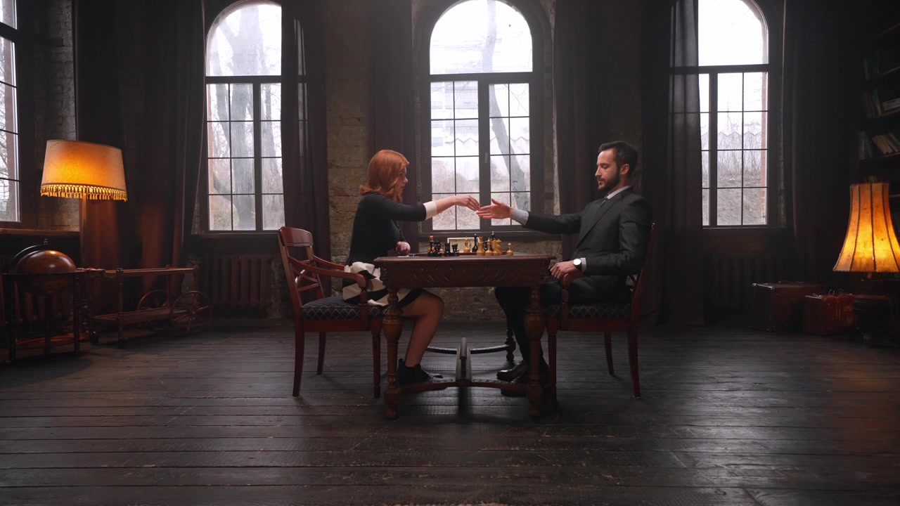 Man and Woman Playing Chess in a Vintage Library Room