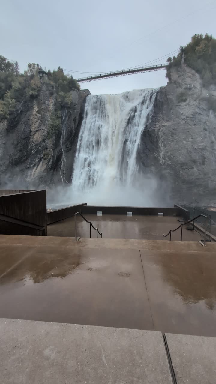 Waterfall in Quebec Canada with suspension bridge and concrete viewing plaform- Montmorency Falls