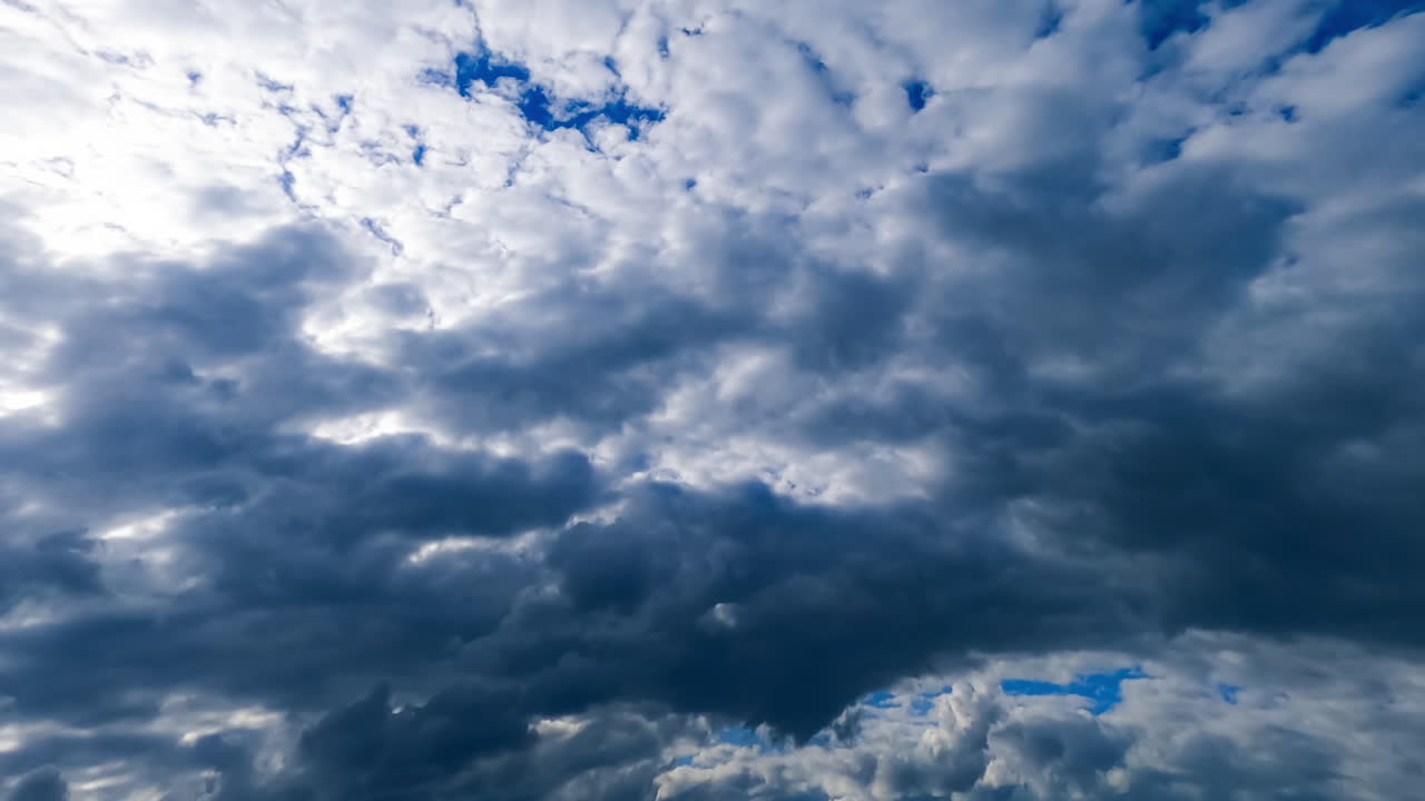 Dark dramatic cloudscape forming in the atmosphere. Grey clouds from low angle view. Timelapse.