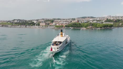 aerial of beautiful old ferry sailing towards the city of lausanne in switzerland