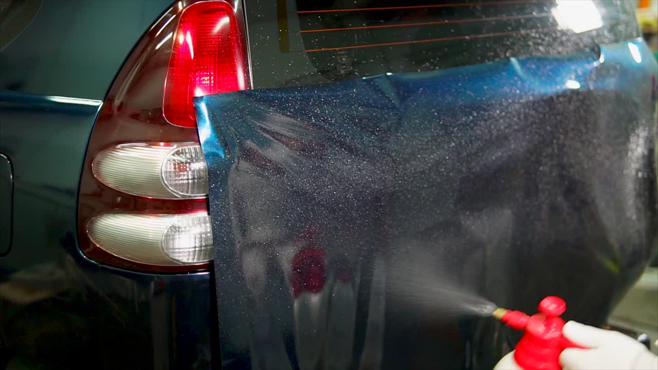 Applying Vinyl Wrap to a Car's Rear Trunk