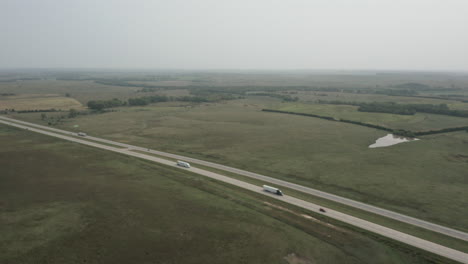 traffic moves along highway running through kansas landscape