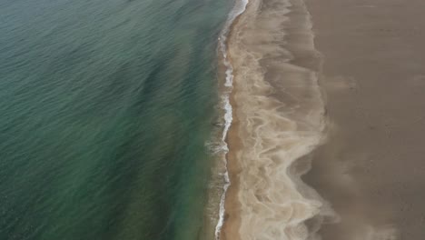 Stunning-wild-sandy-coastline-of-Snæfellsnes-Peninsula-in-Iceland,-drone-tilt-up