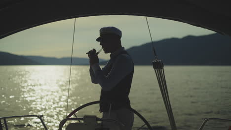 captain on yacht at sunset