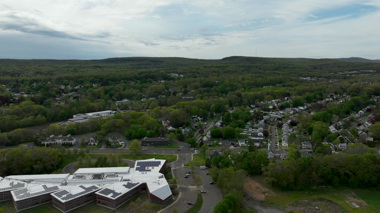 A hyper lapse from behind a school looking out into the distance at mountains
