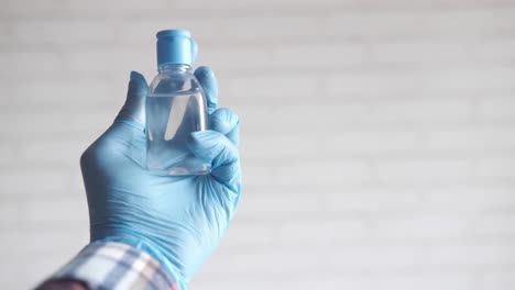 hand sanitizer in blue gloves