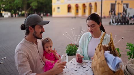 a family enjoys a meal together outdoors