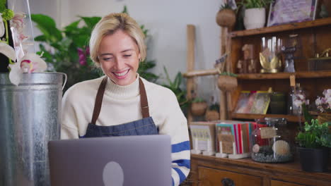 Female-Owner-Of-Florists-Shop-Using-Laptop-Computer-For-Video-Call