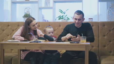 happy man talks to family and smiles holding smartphone