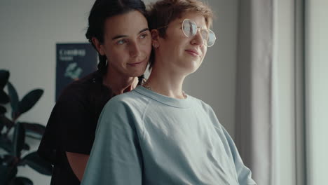 lesbian couple waiting for a baby embracing at home