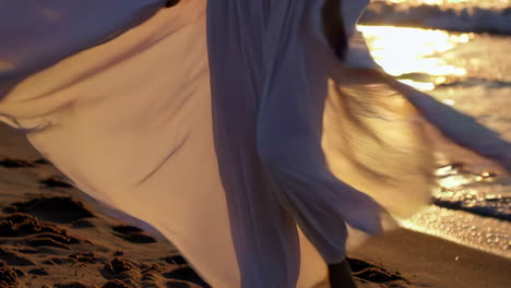 woman in a white dress at sunset beach