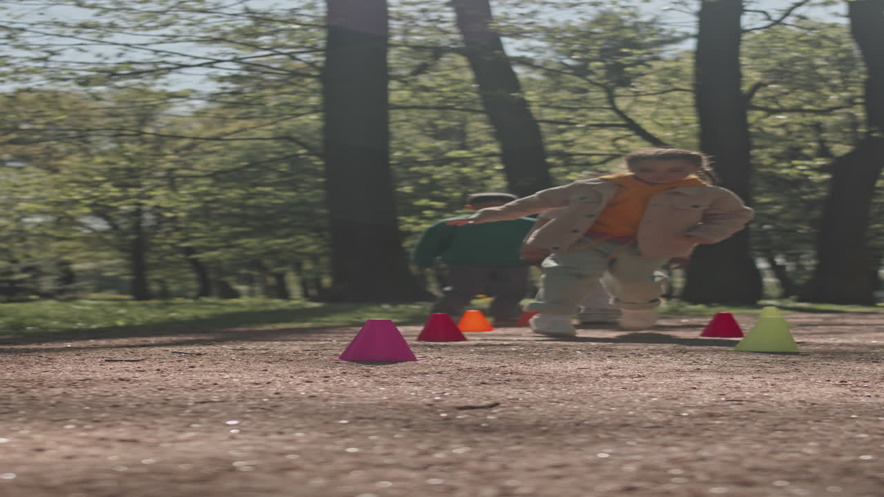 Little Children Running Between Cones in Park