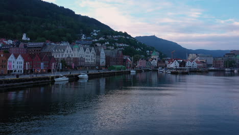 drone shot starting at bryggen in bergen and pushing out to reveal more of the unesco world heritage area