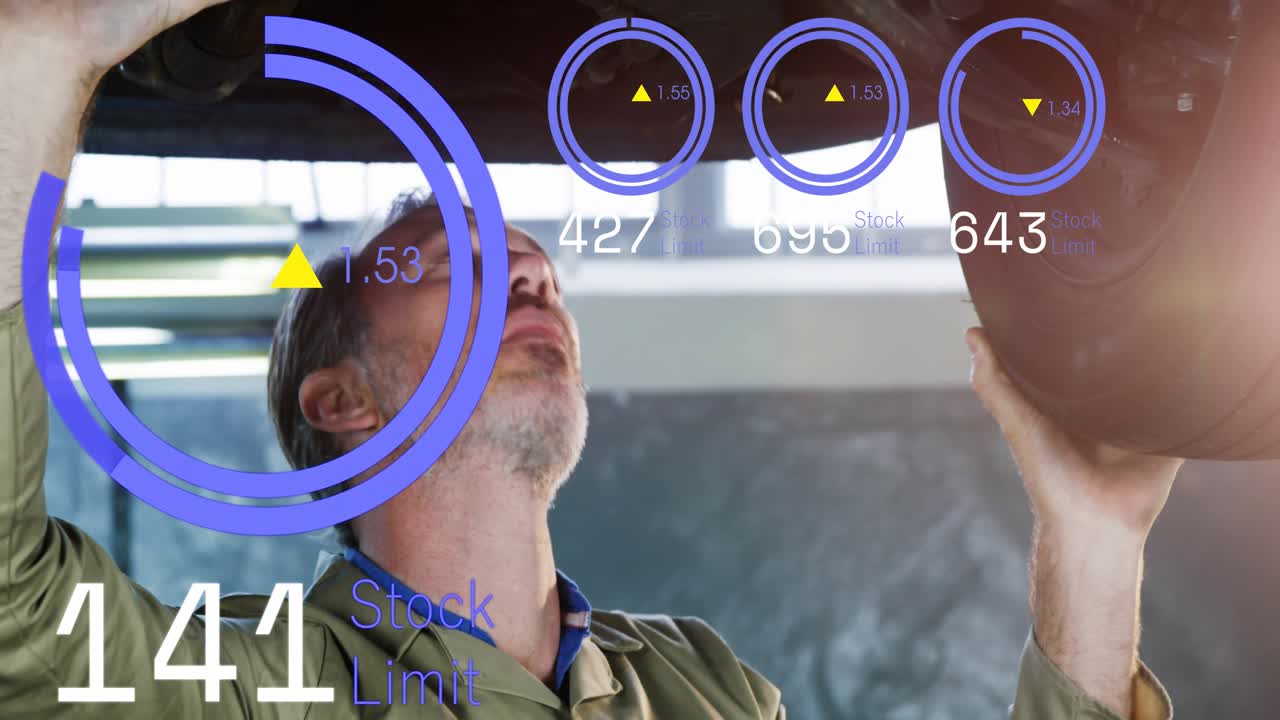 Mechanic reaching up and lifting tire in service bay, AR rings and readouts updating alignment