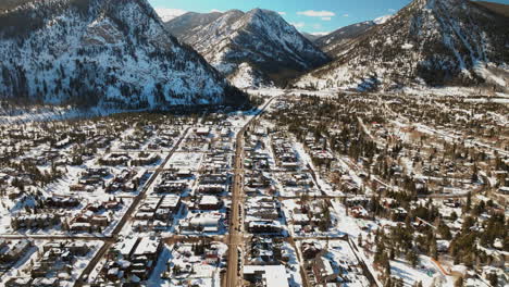 winter bluebird sky daytime noon snowy downtown frisco aerial drone high elevation main street colorado mountain ski town copper ikon pass breckenridge silverthorne dillon summit county backwards pan