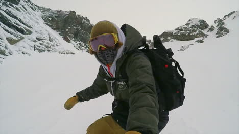 male snowboarding down on a white ski slope in winter time