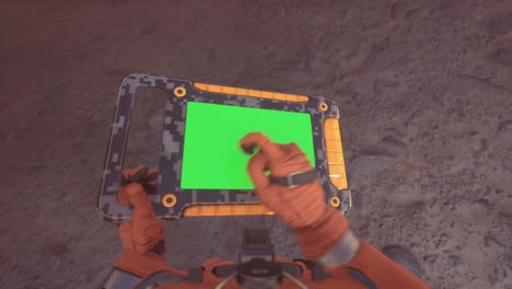 an astronaut on an alien, dusty planet is working on his tablet with a green screen. the animation is designed for sci-fi, science, futuristic or space travel.