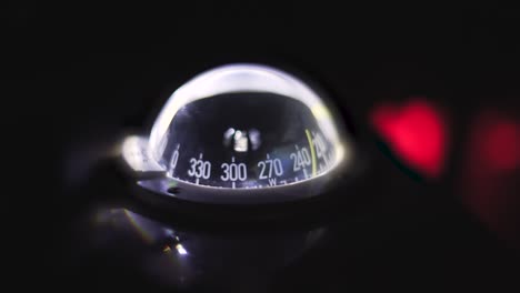 marine compass on a sailing yacht at night. backlit compass