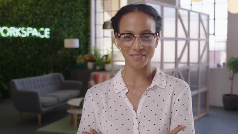 portrait business woman smiling confident happy entrepreneur enjoying successful startup company proud female manager wearing glasses arms crossed in trendy office workspace