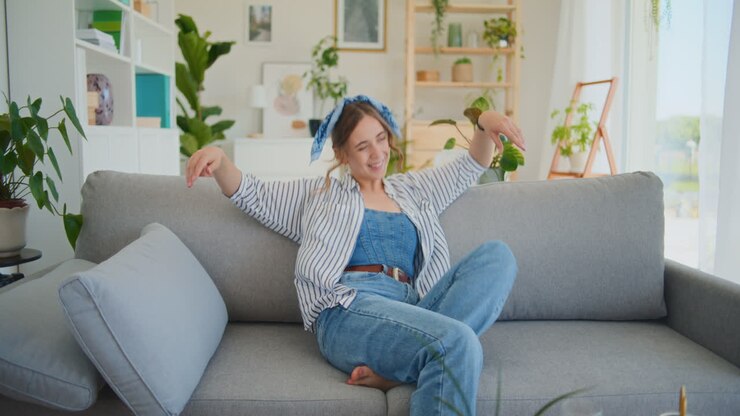 Happy Woman Smiling After Online Shopping on Sofa