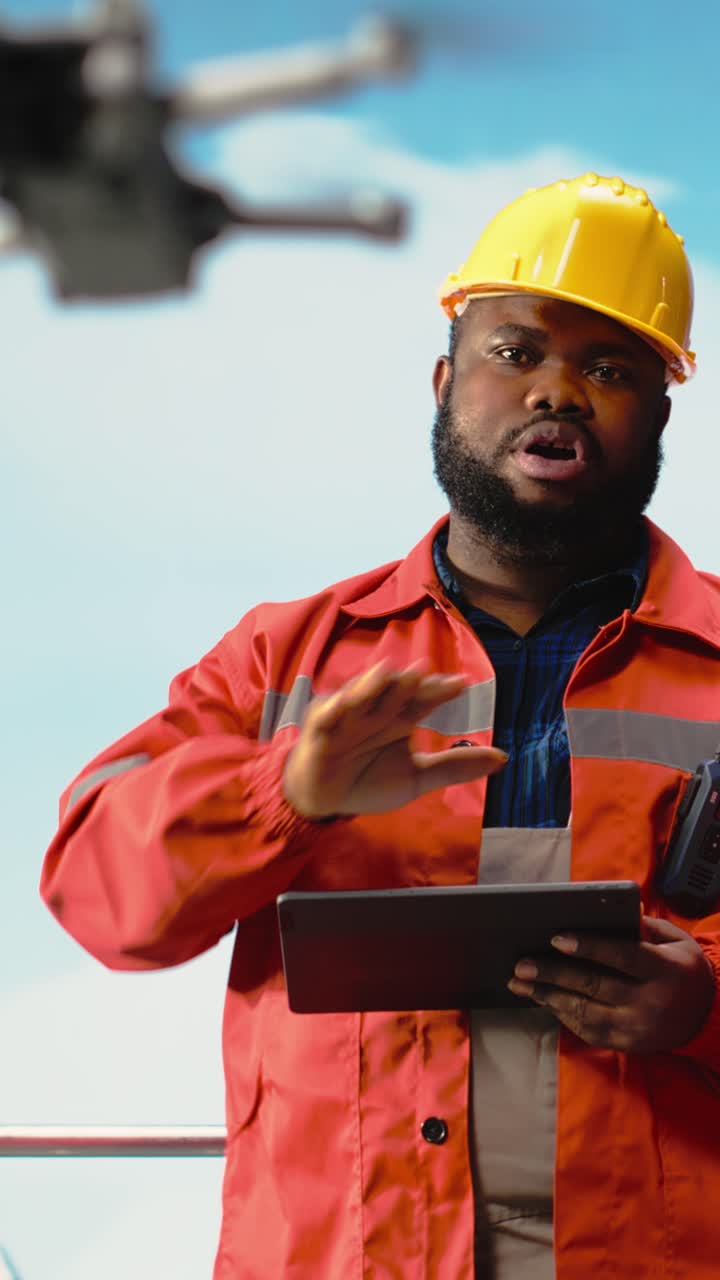 Vertical video Offshore platform professionals working together, using drone