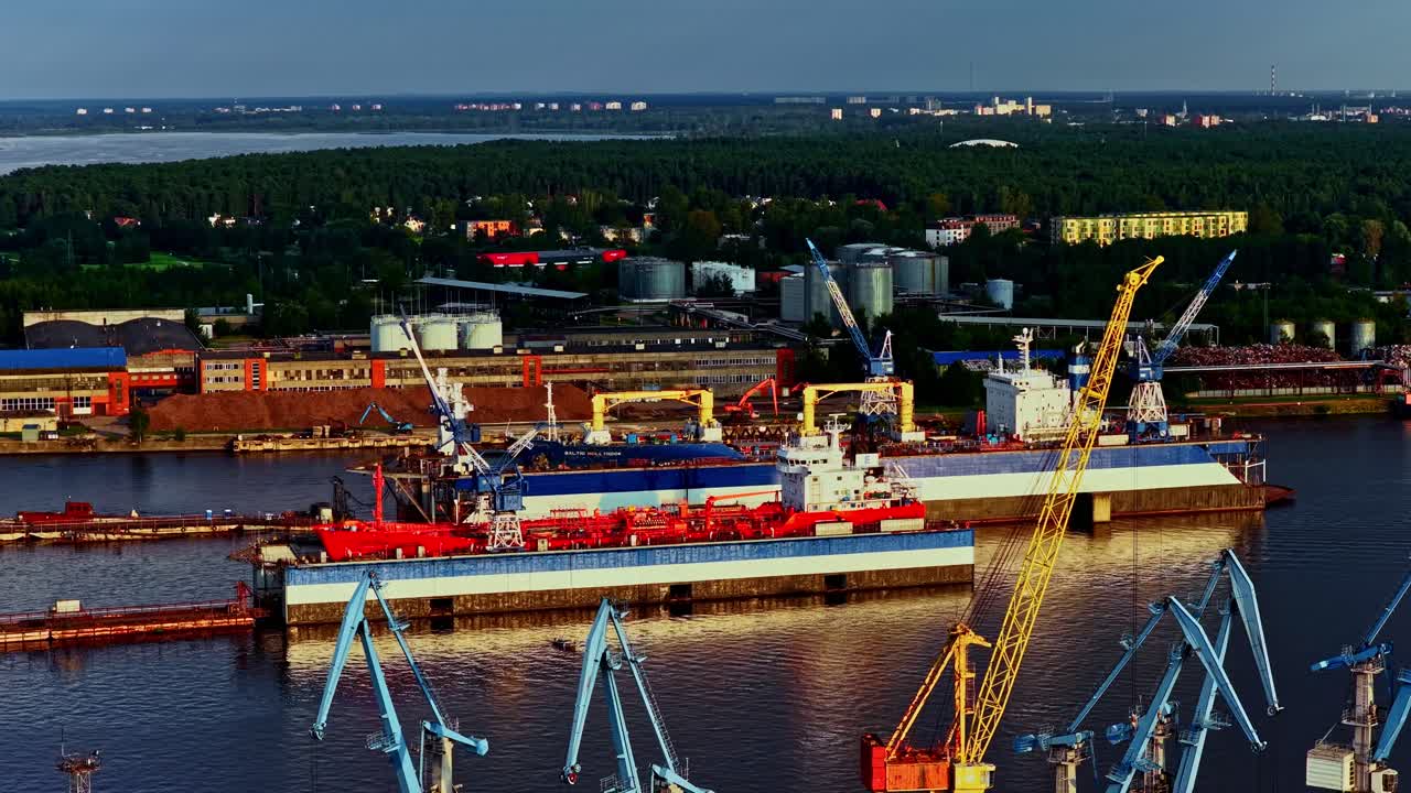 Busy shipyard with cranes and ships under cloudy sky, industrial scene