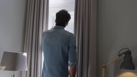 Young-man-looking-through-the-window