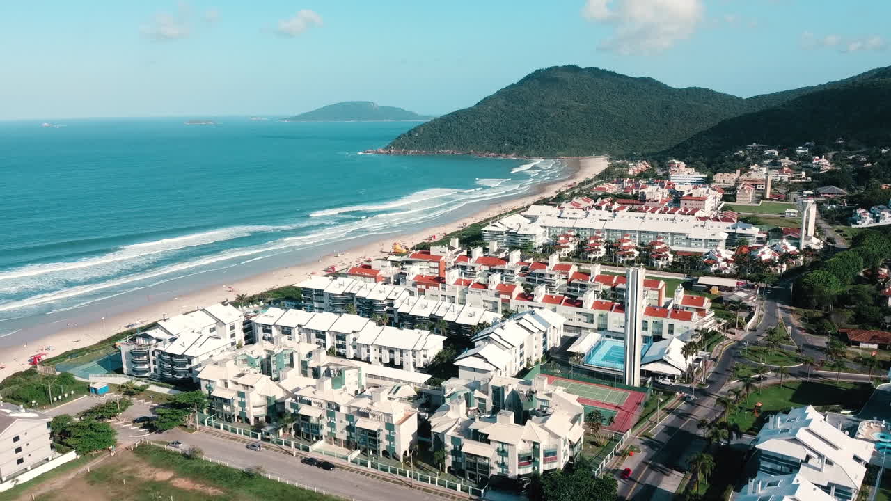 Drone advance covering the entire Praia Brava, Florian&oacute;polis, with the vast azure sea as a breathtaking backdrop, capturing the coastal splendor