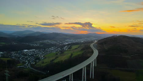 A-Drone's-Perspective-Hyperlapse-of-North-Rhine-Westphalia's-Tallest-Autobahn-Bridge,-Talbrücke-Nuttlar,-during-Golden-Hour