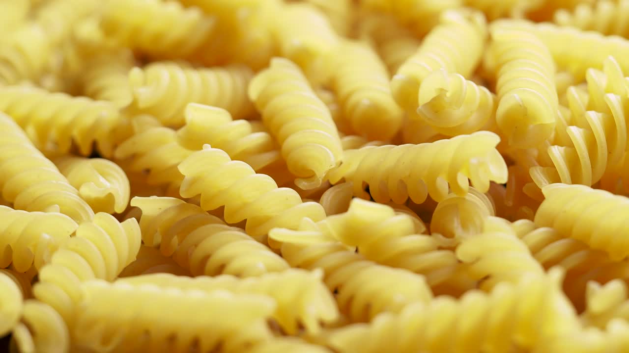 un primer plano de la pasta italiana de fusilli en bruto girando en círculo