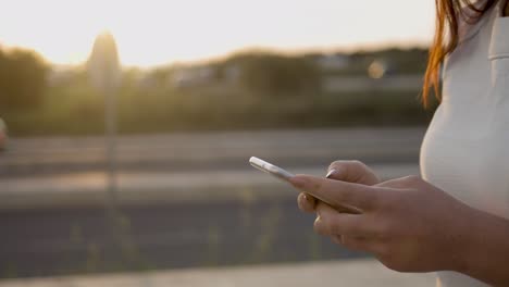 cropped shot of young woman using smartphone