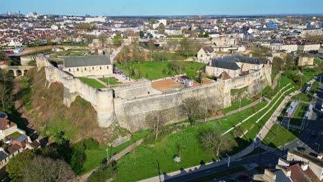 architecture and robust fortifications of chateau de caen in normandy. history, medieval defense. france. aerial drone circling