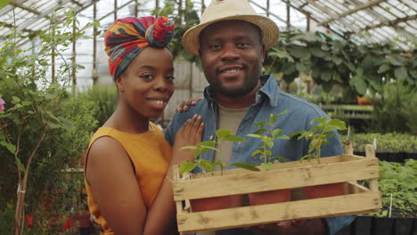 portrait of happy african american couple in greenhouse