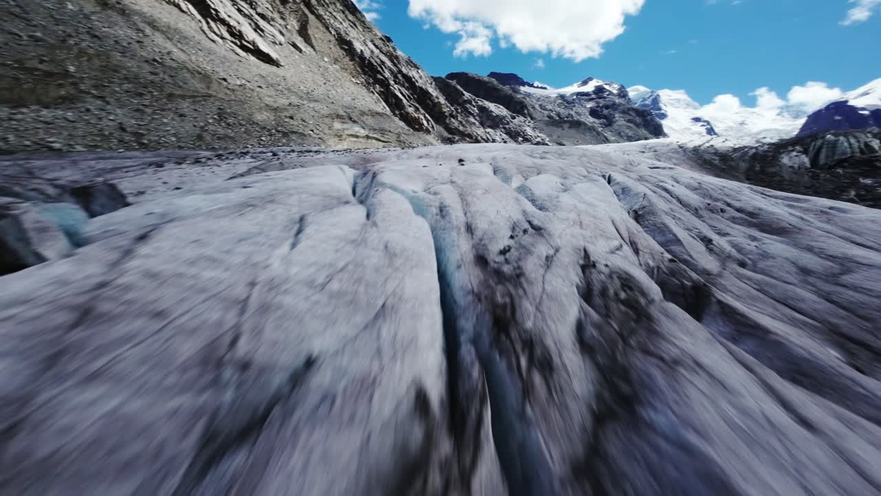 FPV drone flying over rocky Swiss landscape, awe-inspiring natural beauty