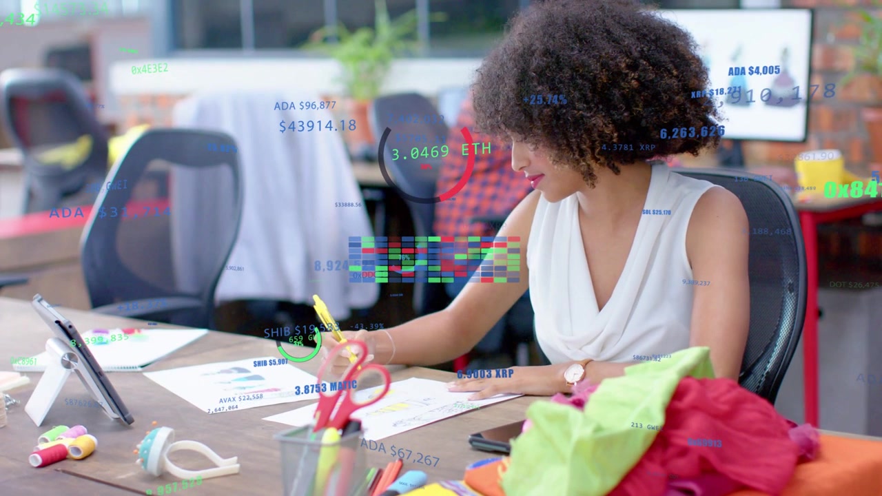 woman marking sketches, checking tablet, creating data charts over desk for design with swatches