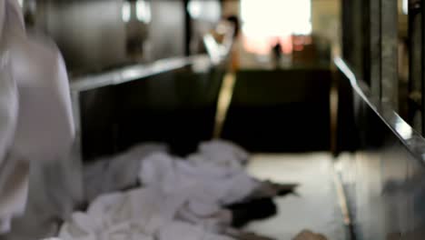 laundry being dropped on conveyor belt