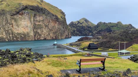 coastal view of iceland's heimaey island harbor with volcanic landscape and mountains