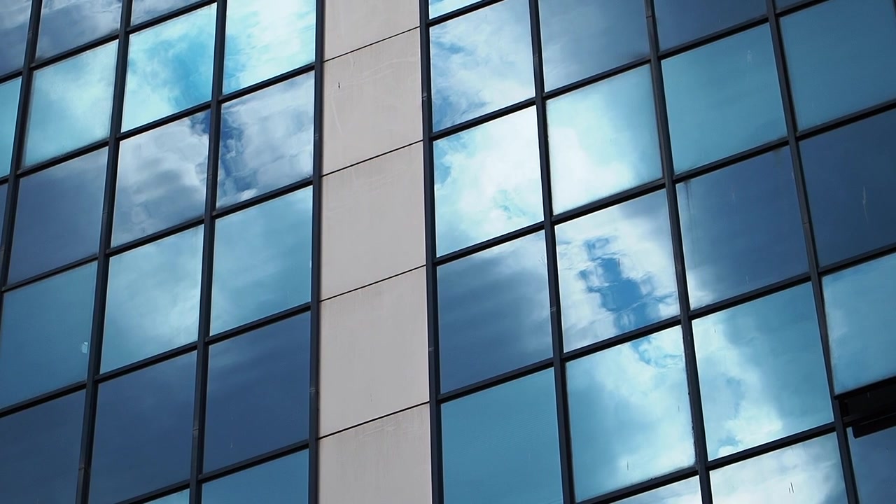 Clouds Reflecting in Modern Office Building Glass Facade