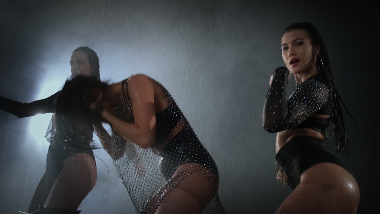 Três Mulheres Dançando na Chuva