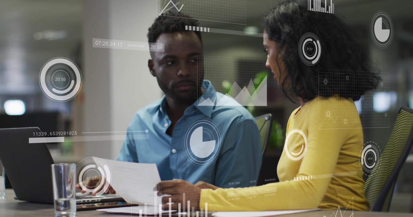 Animation of data processing against diverse man and woman discussing over a document at office