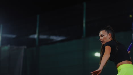 woman playing tennis at night