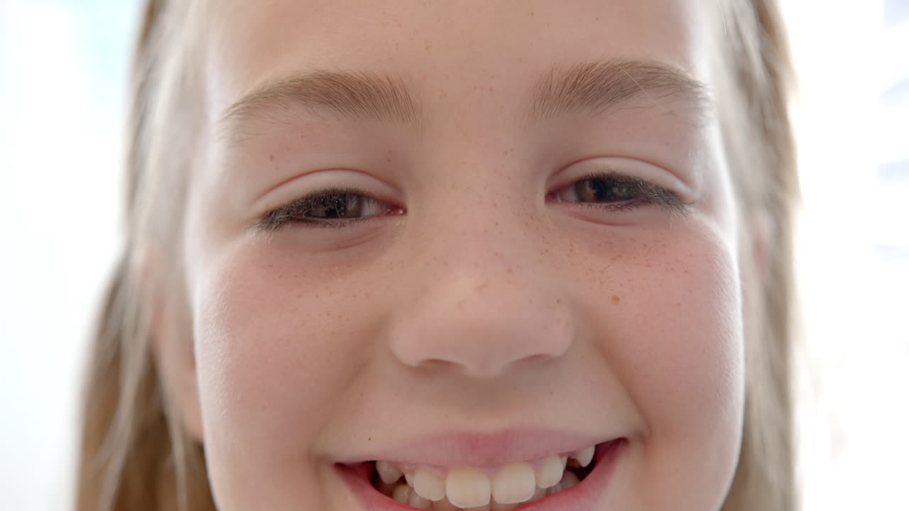 Portrait of happy caucasian girl patient with long hair smiling in hospital, slow motion