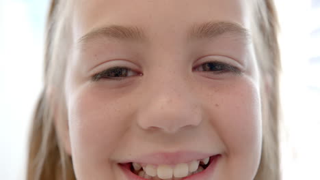 Portrait-of-happy-caucasian-girl-patient-with-long-hair-smiling-in-hospital,-slow-motion