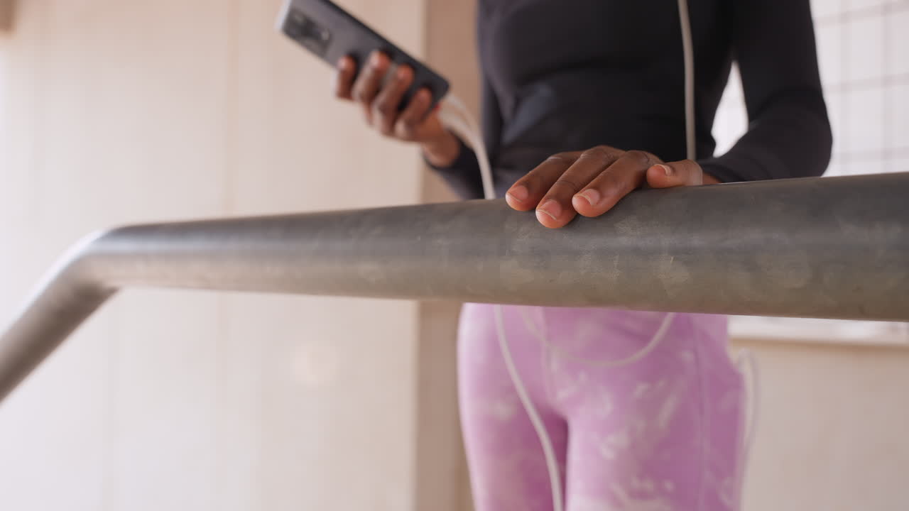 Youthful woman resting. Young lady relaxing outdoors. Casual young woman pauses on city stairs after exercise. Slender woman in casual attire sitting on urban staircase after workout session