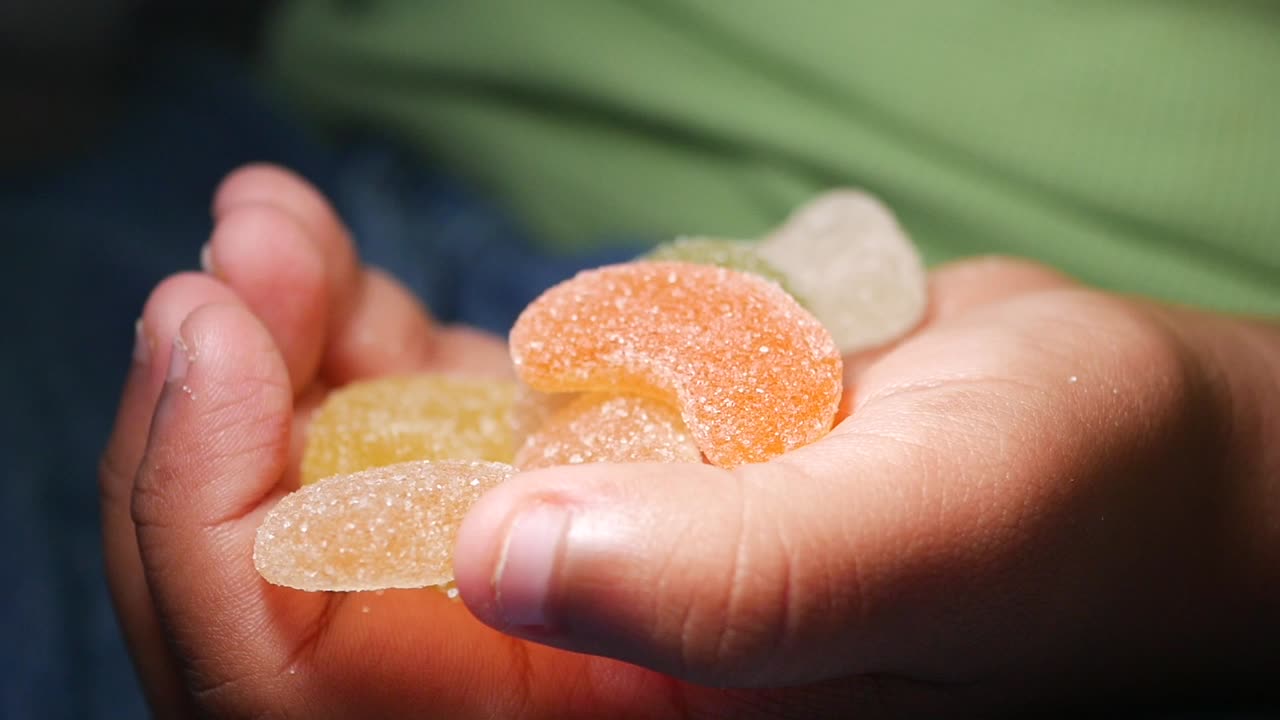 Hand holding gummy candies